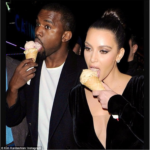 Sugary cravings: Kim Kardashian shared a throwback snap in honour of National Ice Cream Day on Sunday showing her and Kanye slurping some frosty treats 