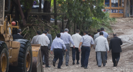 Men touring disaster site