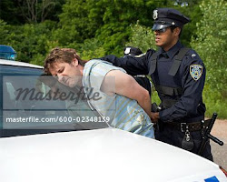 Image of police officer arresting a suspect