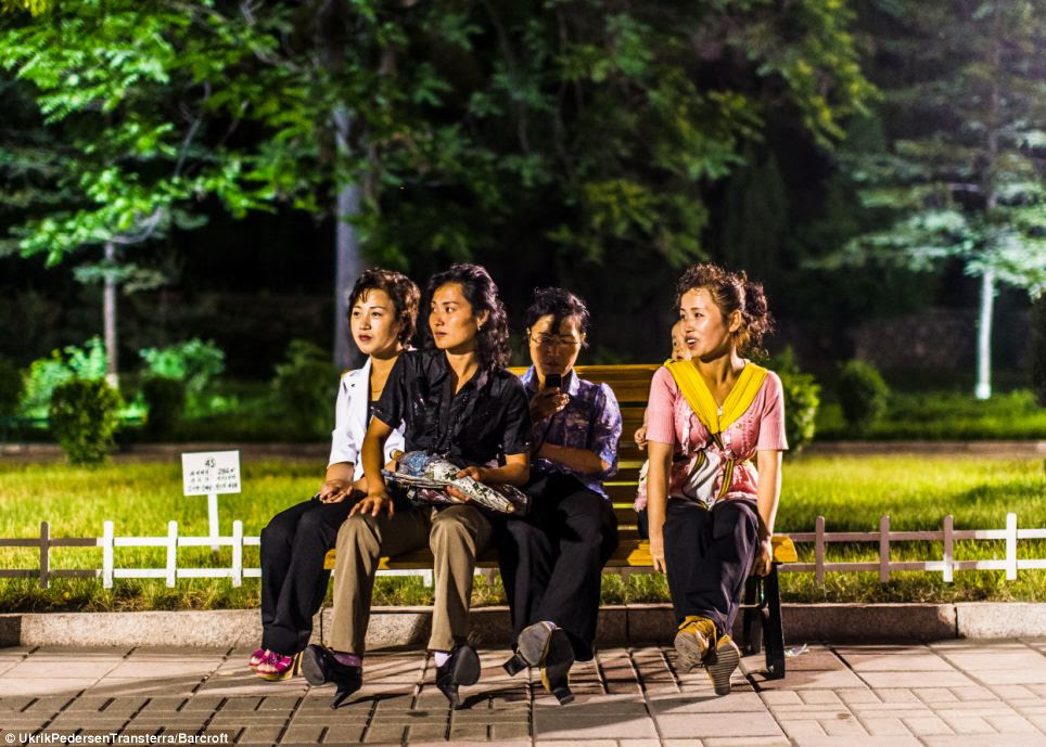 At first Pedersen was amazed to see people living normal lives - such as these women in a 'youth park' in Pyongyang - but he quickly realised he was being deceived