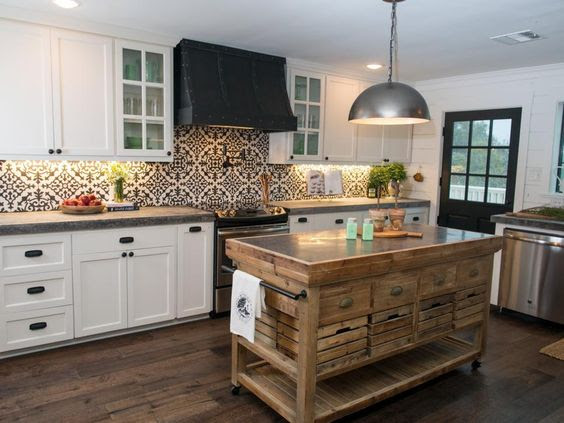 The recipe for this visually balanced kitchen includes plenty of natural wood to help soften the bold visual impact of the black-and-white patterned tile and the contrasting cabinets and countertops.: 