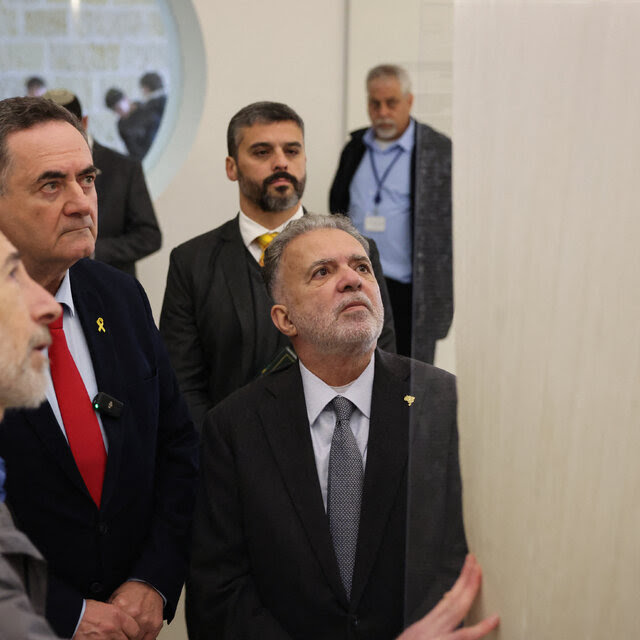 The Brazilian ambassador to Israel, Frederico Meyer, accompanied by Israel’s foreign minister, Israel Katz, looking upward at a display at Yad Vashem, the Holocaust memorial in Jerusalem. 