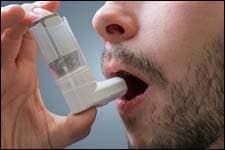 The figure above is a photograph showing a man using an inhaler.