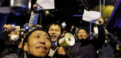 People hold white sheets of paper in protest over coronavirus disease (COVID-19) restrictions after a vigil for the victims of a fire in Urumqi, as outbreaks of COVID-19 continue in Beijing, China, November 28, 2022.