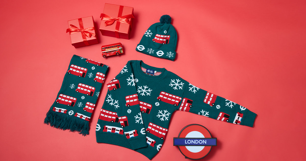 A child's Christmas knitwear, scarf, jumper and hat with London buses, roundels and snowflakes on