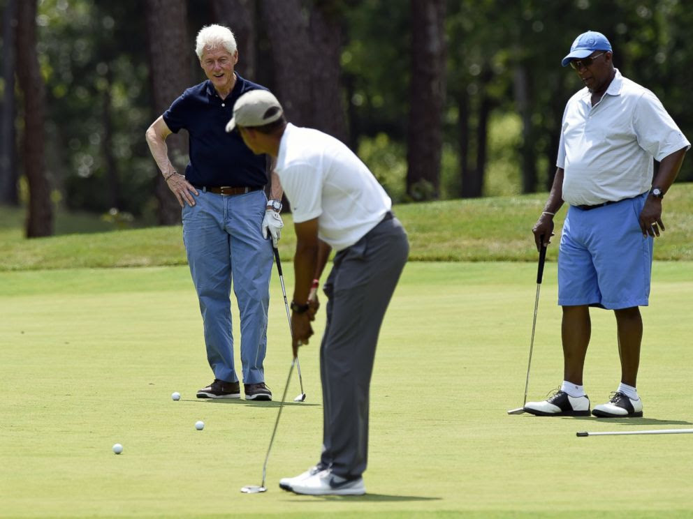 PHOTO: President Barack Obama, center, watches his putt as he plays golf with former President Bill Clinton, left, and Amb. Ron Kirk, right, former United States Trade Representative in Oak Bluffs, Mass., on Marthas Vineyard, Aug. 15, 2015. 