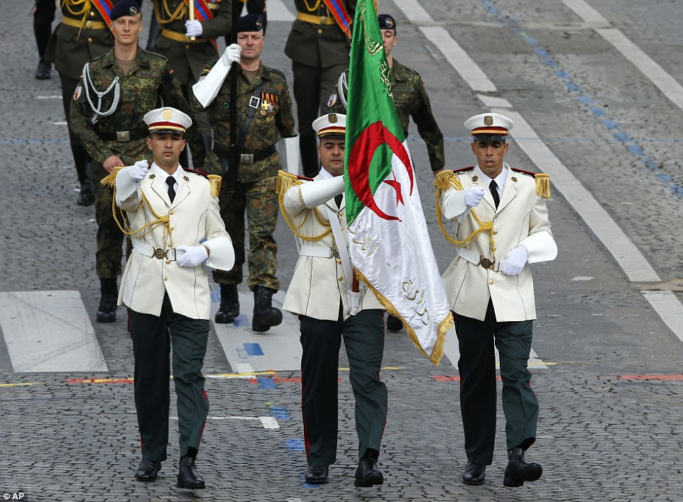 Three Algerian soldiers, pictured, took part in today's parade despite the opposition of French far right politicians. The visit was also controversial in Algeria 