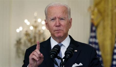 President Joe Biden holding up one finger and about to speak.