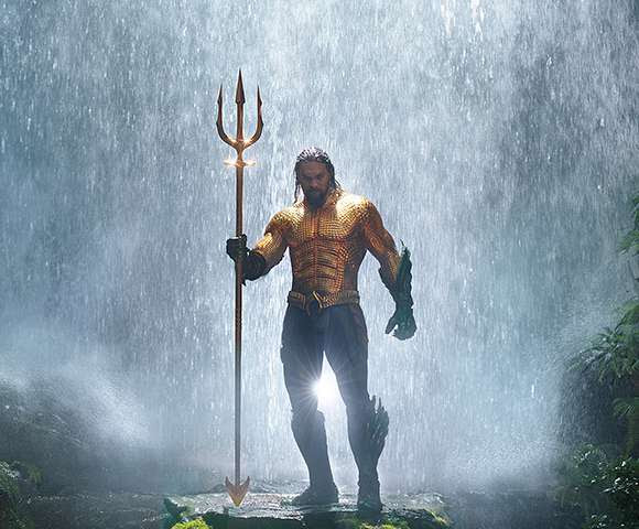 Jason Mamoa as Aquaman standing with his Trident.