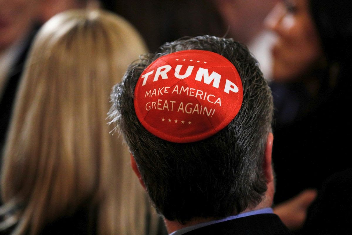 Photo of a man wearing a red MAGA yarmulke 