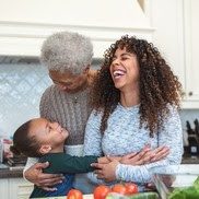 Image of three generations of women laughing together. 