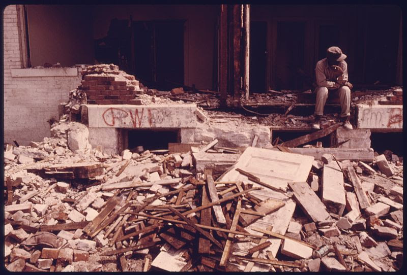 File:MEMBER OF A WRECKING CREW RESTS DURING DEMOLITION OF HOUSING IN THE MULKEY SQUARE AREA. MANY OF THE LOW INCOME... - NARA - 557351.jpg