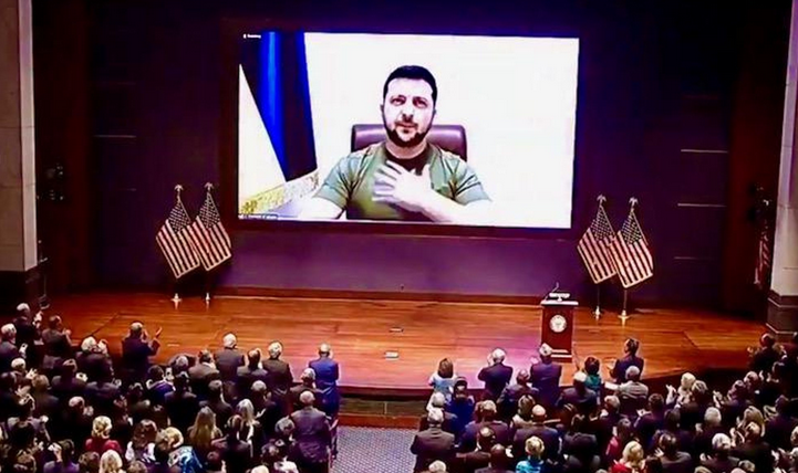Zelenskyy projected on screen getting standing ovation from law-makers.