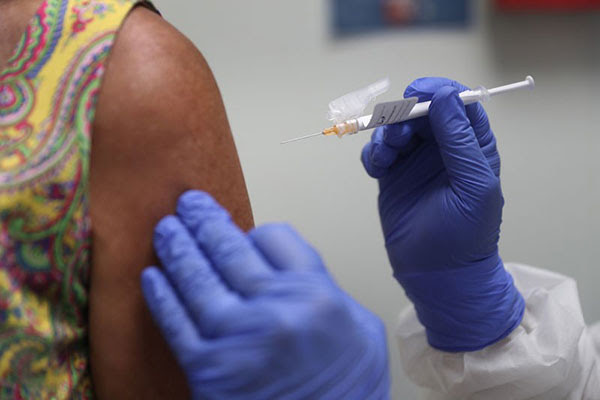 A woman receives a vaccination.