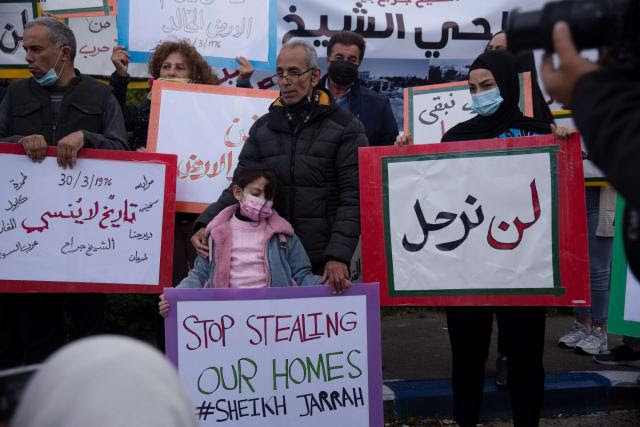 Photo of people holding a vigil to mark Land Day in the Sheikh Jarrah district, where Palestinians are under threat of eviction from their homes, in Jerusalem.