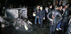 Rescue team members stand amid car wreckages after a bomb explosed on October 03, 1980 at the synagogue rue Copernic in Paris. - A powerful bomb killed three and wounded many others when it exploded outside a Paris synagogue during holiday sabbath services. (Photo by Georges GOBET / AFP)