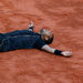 Jo-Wilfried Tsonga, a native of France, wrote a message in the clay Tuesday and then lay down and spread his arms to form the T in 