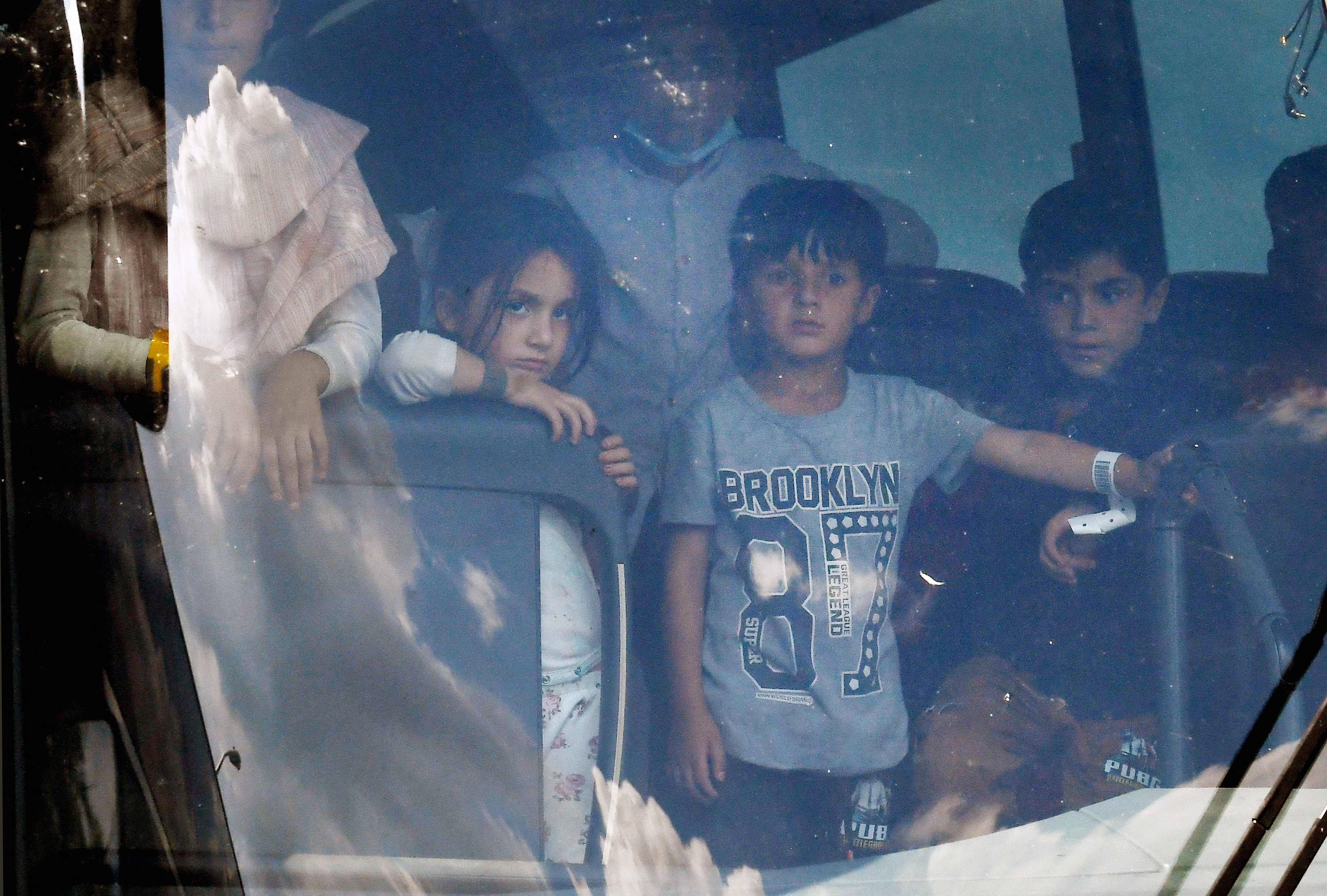 Afghan refugees arrive at a processing center in Chantilly, Va., on Monday. (Olivier Douliery/AFP via Getty Images)