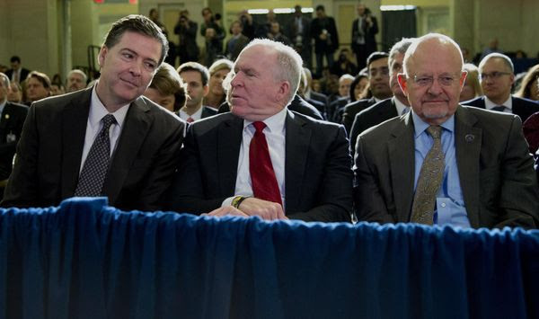 From left, FBI Director James Comey, CIA Director John Brennan, and Director of National Intelligence James Clapper sit together in the front row before President Barack Obama spoke about National Security Agency (NSA) surveillance, Friday, Jan. 17, 2014, at the Justice Department in Washington. The president called for ending the government's control of phone data from millions of Americans. (AP Photo/Carolyn Kaster)