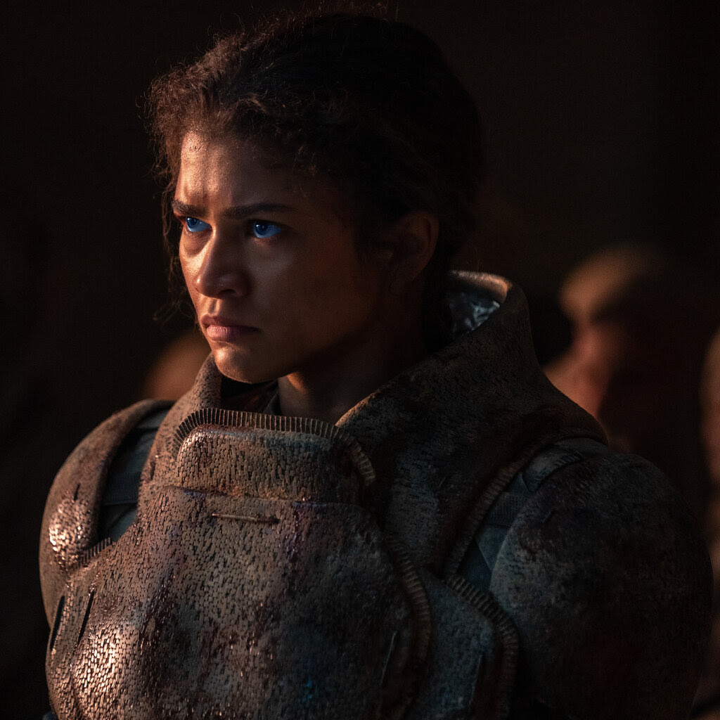 Wearing earth-toned clothing, Zendaya stands out with her glowing blue eyes.