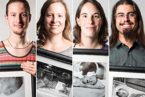 Four people pose with portraits of themselves as premature babies.