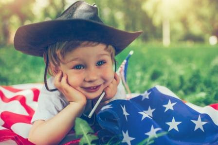 Small Boy in Cowboy Hat and American Flag