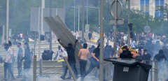 Protesters clash with police during a commemoration march for a teenage driver shot dead by a policeman, in the Parisian suburb of Nanterre, on June 29, 2023. Violent protests broke out in France in the early hours of June 29, 2023, as anger grows over the police killing of a teenager, with security forces arresting 150 people in the chaos that saw balaclava-clad protesters burning cars and setting off fireworks. Nahel M., 17, was shot in the chest at point-blank range in Nanterre in the morning of June 27, 2023, in an incident that has reignited debate in France about police tactics long criticised by rights groups over the treatment of people in low-income suburbs, particularly ethnic minorities. (Photo by Alain JOCARD / AFP)