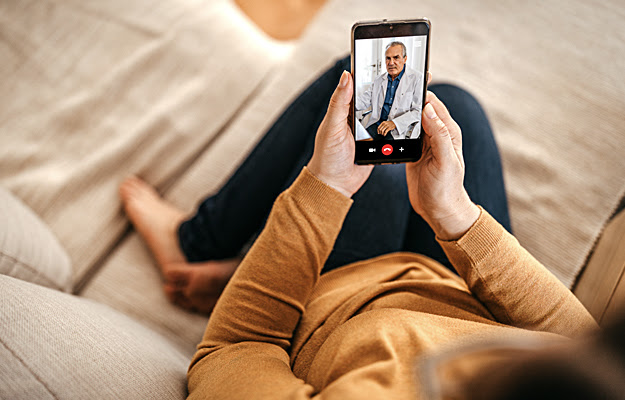 A woman having a video session with a doctor.