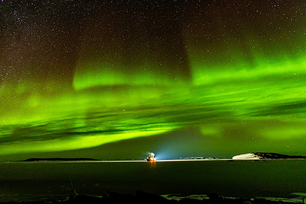 R/V Nathaniel B. Palmer at Davis Station anchorage with aurora borealis light show overhead