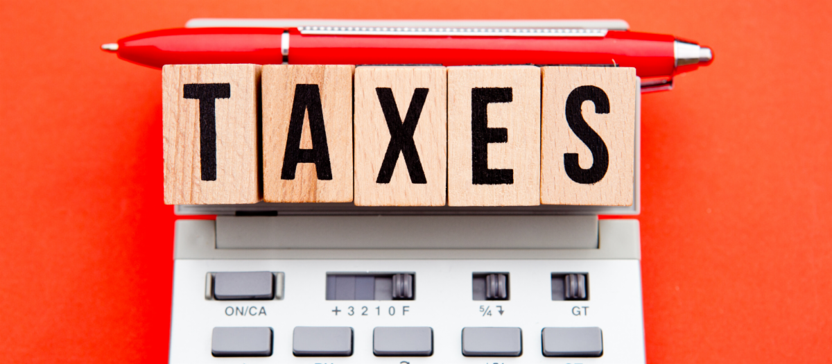 Image of pencil and building blocks spell the word taxes