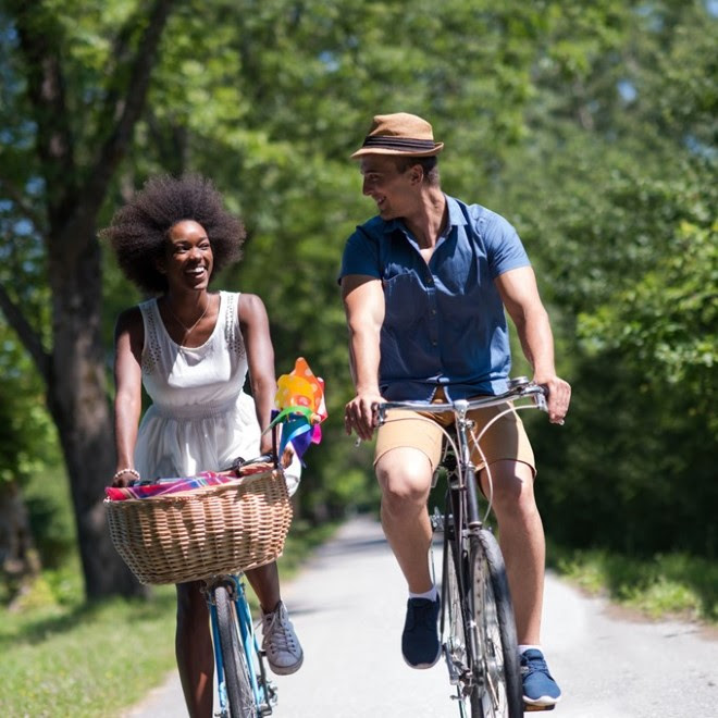 Two people riding their bikes