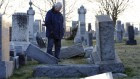 A man looks at fallen tombstones at the Jewish Mount Carmel Cemetery, February 26, 2017, in Philadelphia, PA.  (DOMINICK REUTER/AFP/Getty Images, via JTA)