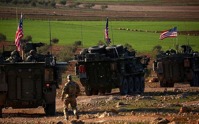 US forces armored vehicles drive near the village of Yalanli, on the western outskirts of the northern Syrian city of Manbij, March 5, 2017. (DELIL SOULEIMAN/AFP)