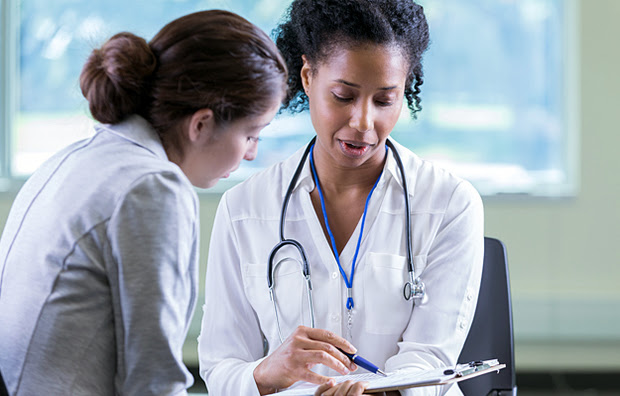 A patient discussing her health condition with a doctor.