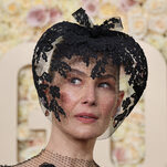 actress rosamund pike's face which is covered by a black lace headpiece