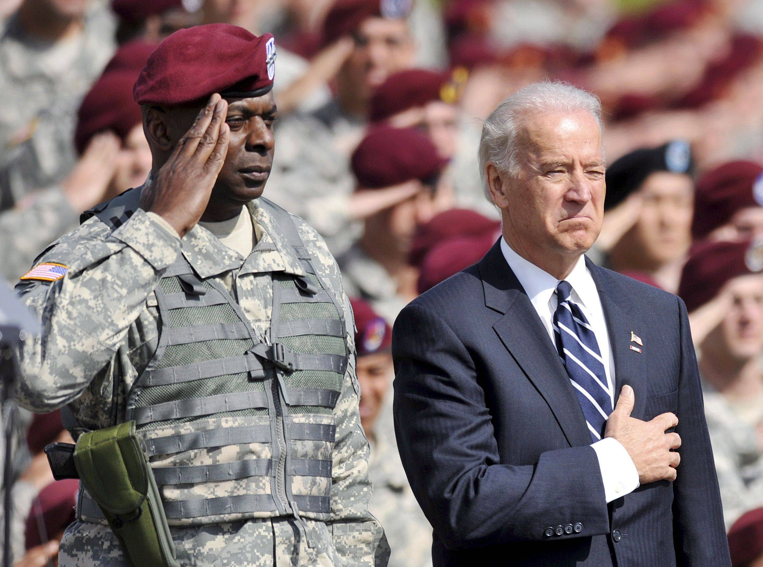 Then-Vice President Joe Biden stands for the National Anthem with then-Gen. Lloyd Austin during a 2009 ceremony at Fort Bragg in North Carolina. (Stan Gilliland/EPA-EFE/Shutterstock)