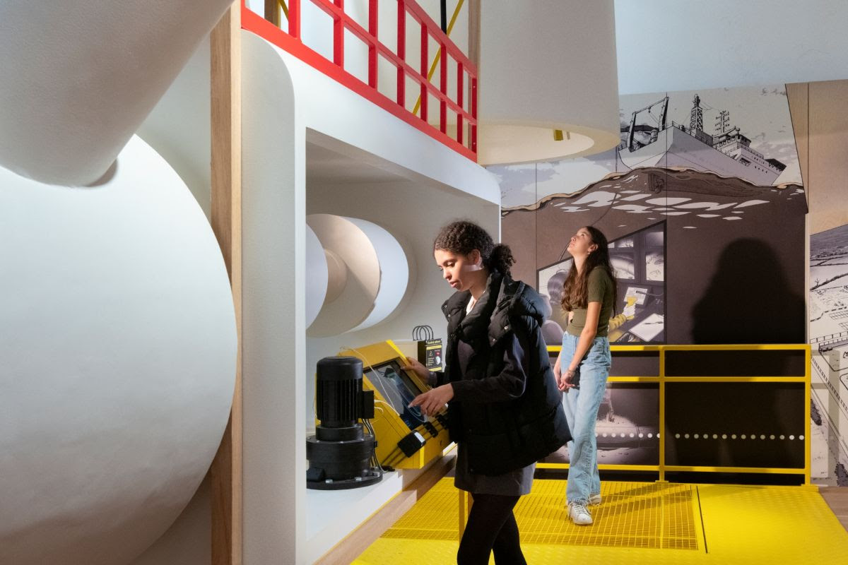 Two students looking at gallery exhibits 