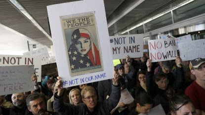 Demonstrators hold signs during a rally against a ban on Muslim immigration at San Francisco International Airport on January 28, 2017 in San Francisco, California. ( Stephen Lam/Getty Images/AFP)