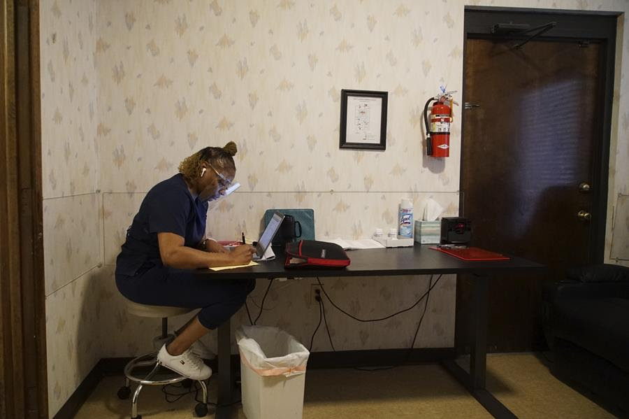Ramona, who asked that her last name not be used, works in the recovery room at the West Alabama Women's Center in Tuscaloosa, Ala., on Tuesday, March 15, 2022. The green case against the wall contains her Bible, which she reads every day during her lunch break.