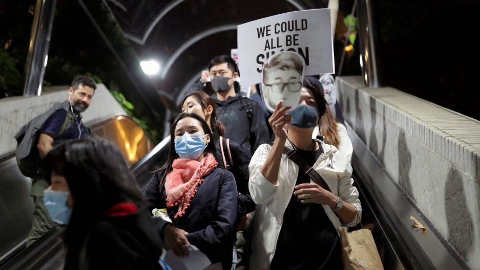 Anti-government protesters ride an escalator at a shopping mall during a rally in Hong Kong, China, Nov. 29, 2019.