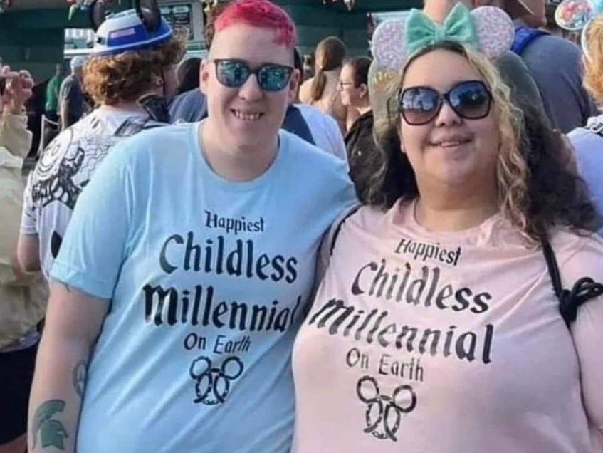Picture of two odd looking people wearing same t-shirt about being happy.