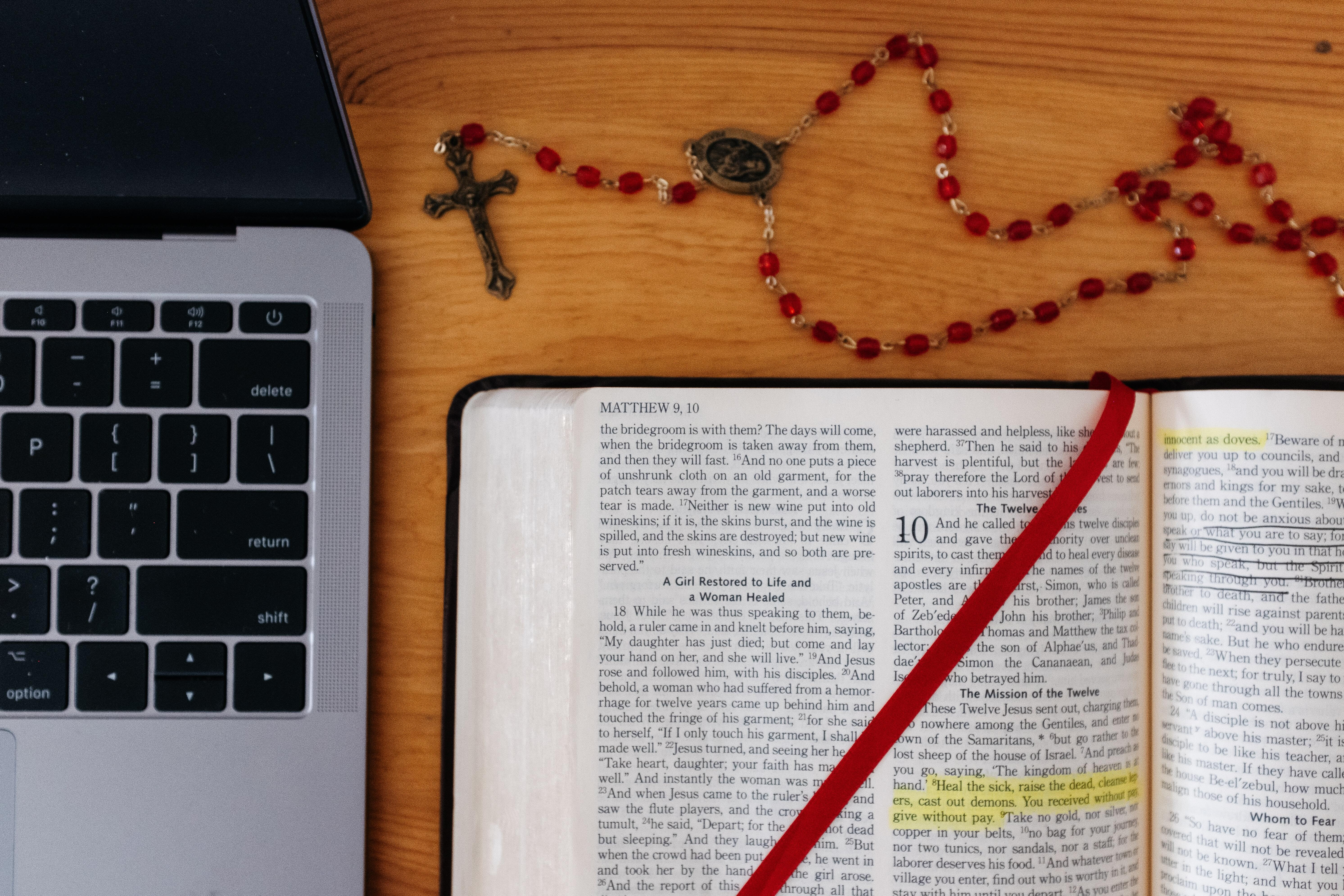 Laptop, rosary, and bible