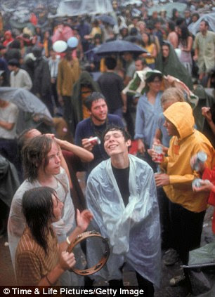 Faces in crowd during rainy spell at Woodstock