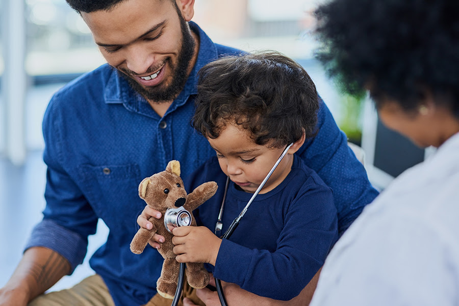 child with parent and healthcare provider