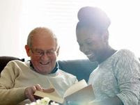 image of a young woman reading a book with an elderly man