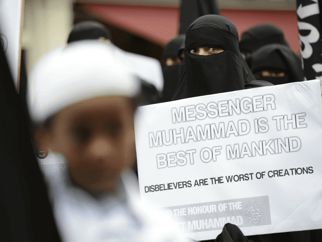 Muslim protesters hold signs as they demonstrate against a French magazine that published nude cartoons of the Prophet Mohammed outside the French embassy in London on September 21, 2012. Around 100 protesters shouted slogans outside the French embassy in London over the cartoons at the same time as violent demonstrations …