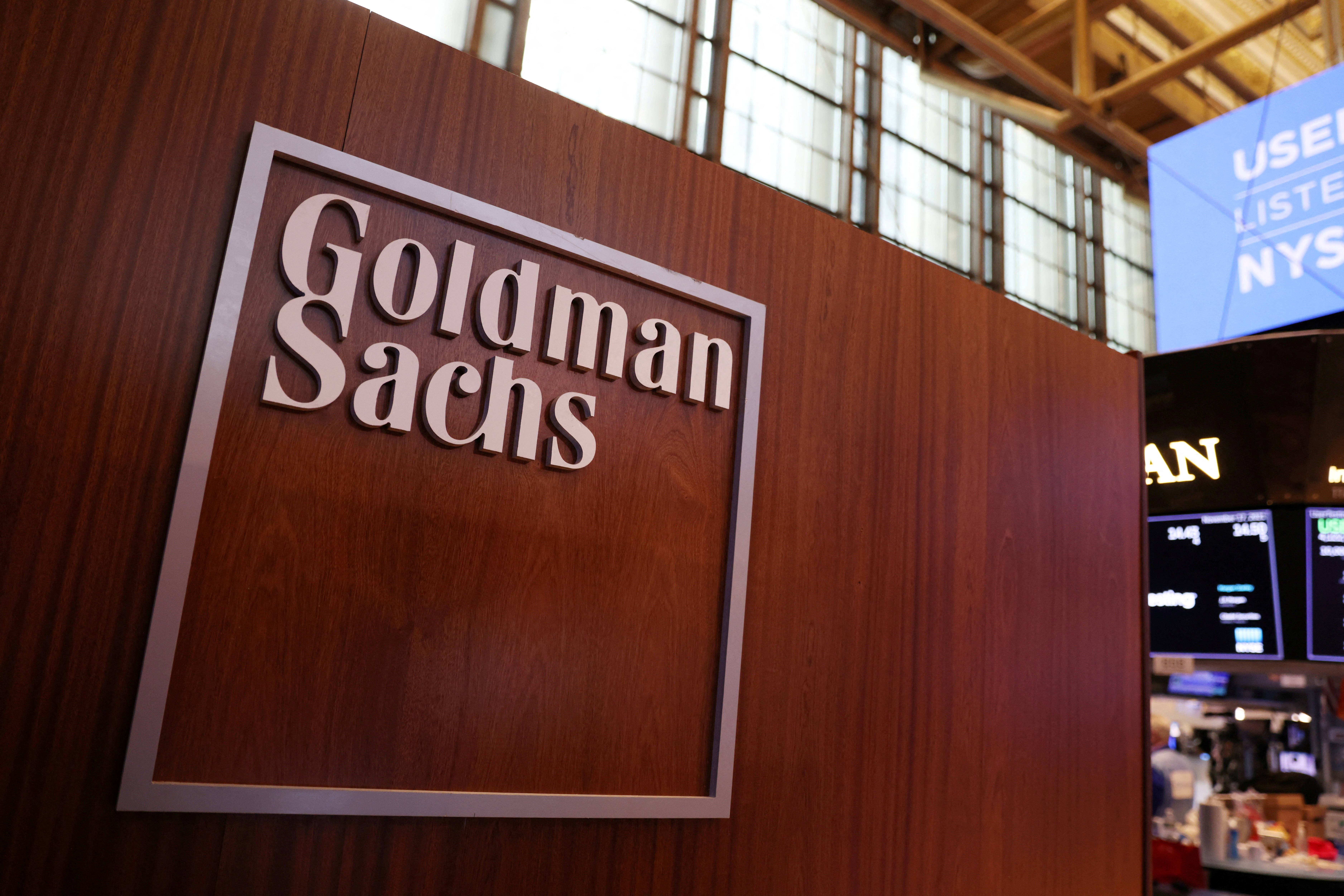 FILE PHOTO: The logo for Goldman Sachs is seen on the trading floor at the New York Stock Exchange (NYSE) in New York City, New York, U.S., November 17, 2021. REUTERS/Andrew Kelly/File Photo