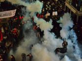 Turkish riot police storm the offices of Today's Zaman, using tear gas and water cannon against protesters, pushing and beating newspaper staff inside the building.