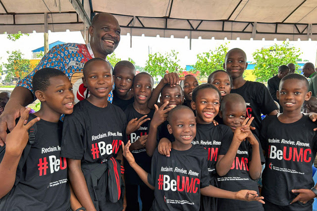 The Rev. Lloyd Nyarota smiles with a group of children from Changombe First United Methodist Church in Dar es Salaam, Tanzania, during the United Methodist Africa Forum meeting Jan 4-7. Photo courtesy of the Rev. Lloyd Nyarota.