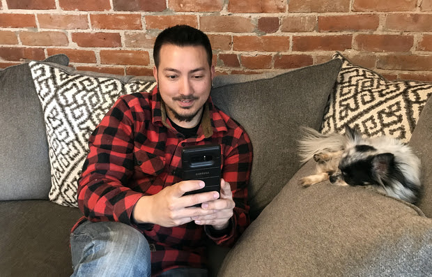 A man using his cell phone to look up health information on MedlinePlus.